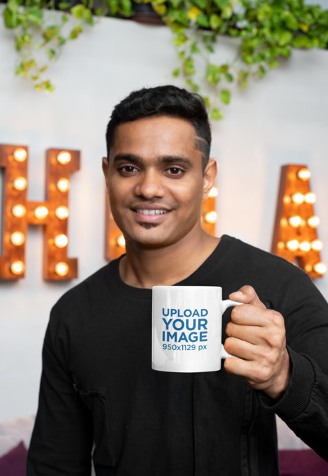 11 oz Coffee Mug Mockup of a Young Smiling Man in Front of a Marquee Sign