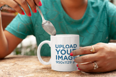Mockup of a Woman Holding Her 11 oz Coffee Mug at a Restaurant