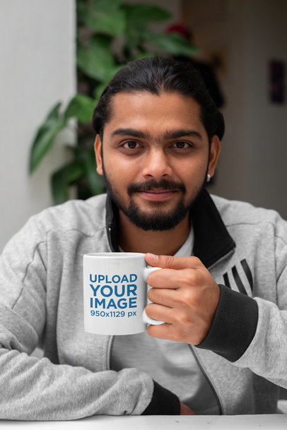 11 Oz Coffee Mug Mockup of a Man with a Plant in the Background