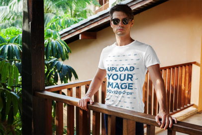Tee Mockup Featuring a Man with Sunglasses at a Tropical Location 
