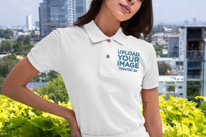 Mockup of a Woman Wearing a Polo Shirt Against a City Background 