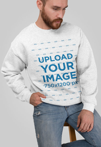 Heathered Crewneck Sweatshirt Mockup Featuring a Man Sitting on a Stool