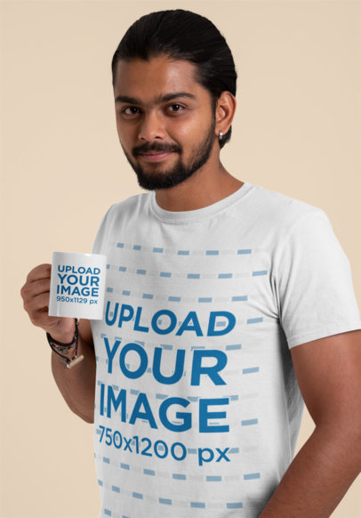 T-Shirt Mockup of a Man Holding an 11 oz Mug in a Studio
