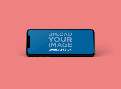 Mockup of an iPhone XS Max Leaned in Portrait Position at a Colored Spot 252-el