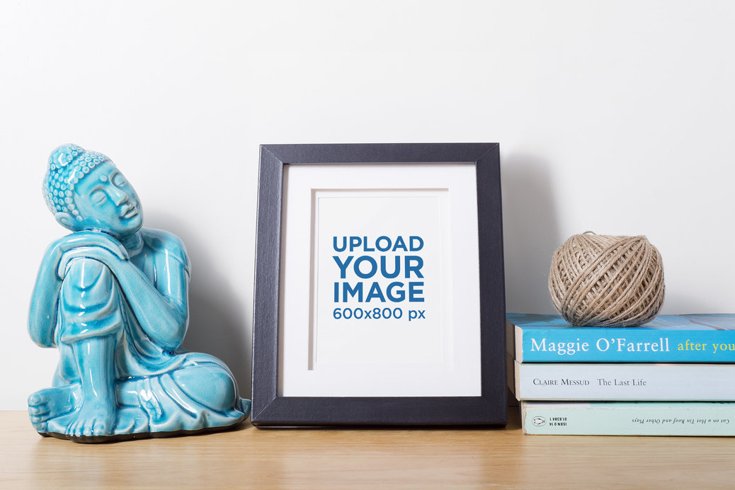 Mockup of a Photo Frame on a Shelf with Intellectual Stuff