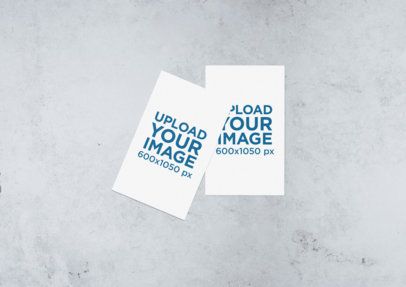 Minimal Mockup of Two Business Cards Lying on a Stone Surface  