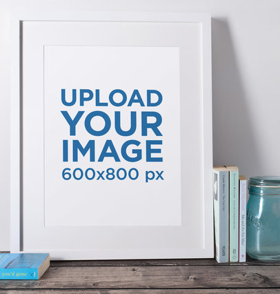 Mockup of a Picture Frame Placed over a Wooden Surface by Some Books