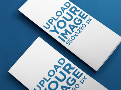 Mockup Template of a Set of Trifold Brochures Lying Over a Solid Surface