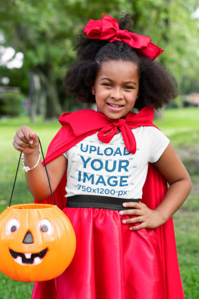 T-Shirt Mockup of a Girl with a Halloween Custome Posing at a Park 