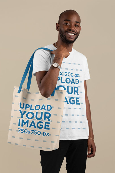 T-Shirt Mockup of a Man Carrying a Customizable Strap Tote Bag Against a Flat Background