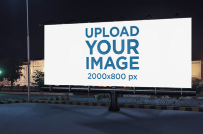 Mockup of a Billboard Standing by a City Street at Night 