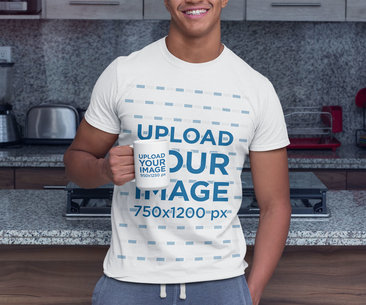 T-Shirt Mockup Featuring a Man Holding a 15 Oz Coffee Mug in the Kitchen 