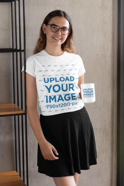 T-Shirt Mockup of a Woman Holding a 15 oz Mug Against a Concrete Wall 29299