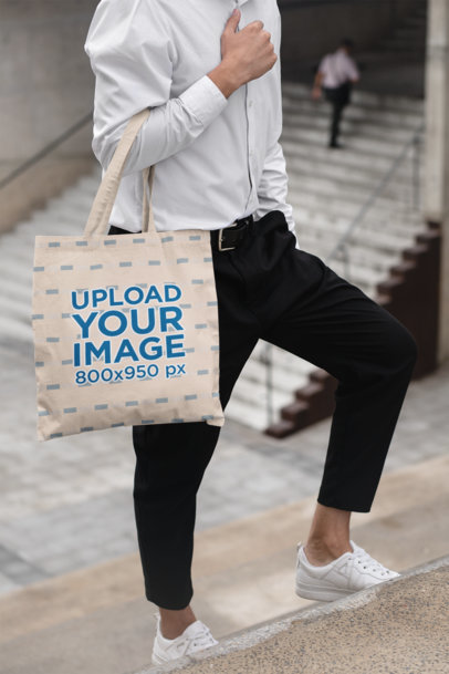 Tote Bag Mockup Featuring a Young Man in a Casual Chic Outfit 