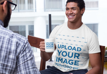 Mockup of a Smiling Man Wearing a Crewneck Tee and Holding a 15 oz Coffee Mug