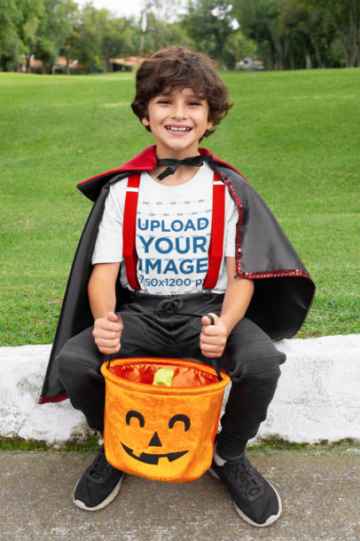 Mockup of a Boy Wearing a T-Shirt and Holding His Pumpkin Basket