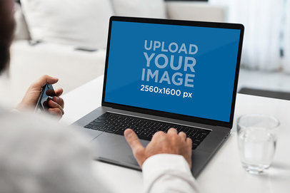 Mockup of a Man at His Home Using a MacBook Pro