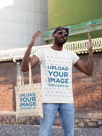 T-Shirt Mockup of a Cool Man Raising His Hands While Carrying a Tote Bag 29438