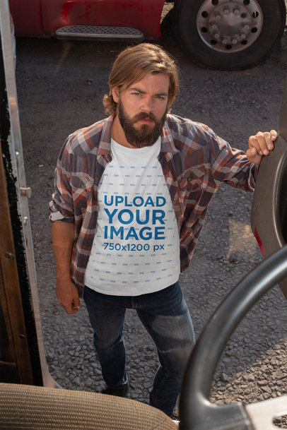 T-Shirt Mockup of a Truck Driver Standing By a Truck's Door 