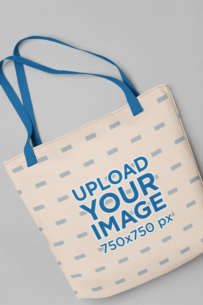 Mockup of a Tote Bag with Customizable Strap Placed over a Flat Surface