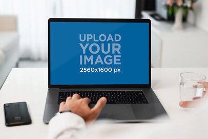 MacBook Pro Mockup Featuring a Man Working at Home 