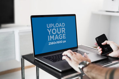 MacBook Pro Mockup Featuring a Man Working on His Laptop 