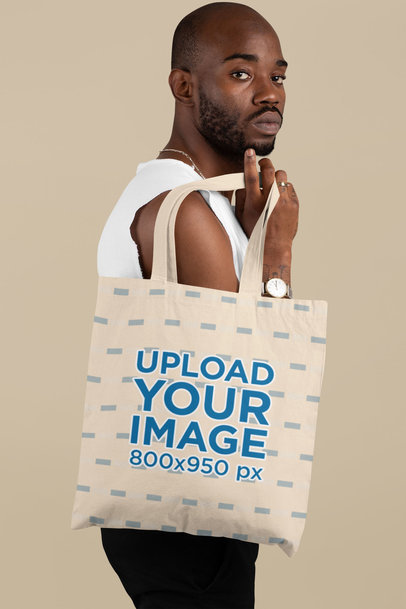 Mockup Featuring a Serious-Looking Man Carrying a Tote Bag over His Shoulder