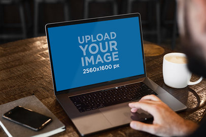 Mockup Featuring a MacBook Pro Placed on a Wooden Table and Next to a Cappuccino 487-el