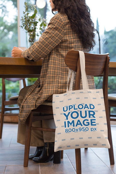 Tote Bag Mockup of a Woman Sitting on a Chair