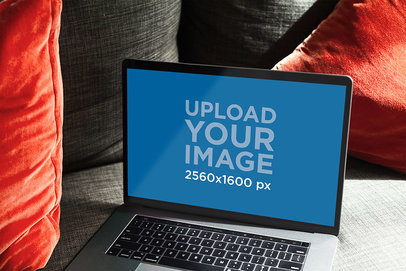 Mockup of a MacBook Pro on a Couch with Red Pillows 490-el
