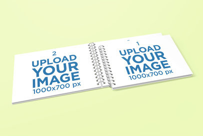 Mockup Featuring Two Spiral Notebooks Placed over a Solid Color Surface 