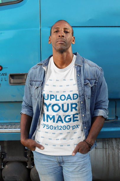 Mockup of a Truck Driver with a Customizable T-Shirt Standing Next to a Truck 