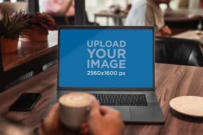 MacBook Pro Mockup Featuring a Man Working at a Coffee Shop 