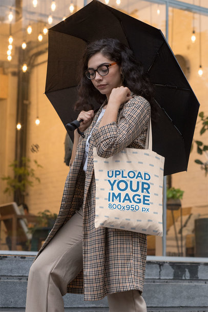 Mockup of a Fancy Woman Carrying a Tote Bag on a Rainy Afternoon 