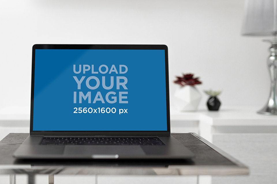 Placeit - Mockup Featuring a MacBook Pro Placed on a Small Dark Wood Table