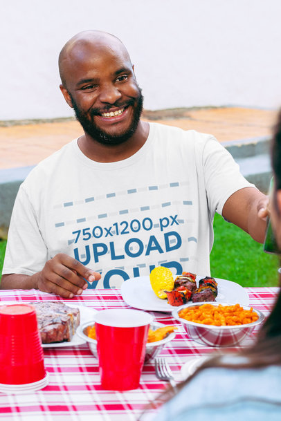 Mockup of a Bald Man Wearing a Crewneck T-Shirt at a BBQ Party 