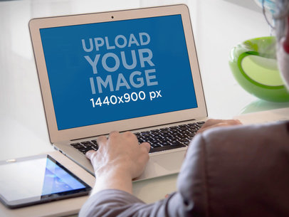 Mockup Featuring a Business Woman Working on a MacBook Air 