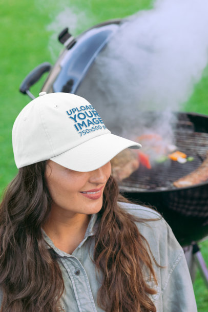 Mockup of a Woman at a BBQ Party Wearing a Dad Hat