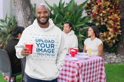 Pullover Hoodie Mockup of a Man at a BBQ Party