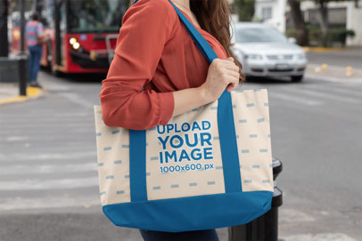 Mockup of a Woman in the Street Carrying a Sublimated Weekend Tote Bag