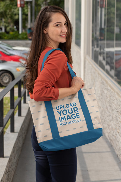 Mockup of a Smiling Woman Holding a Weekend Bag