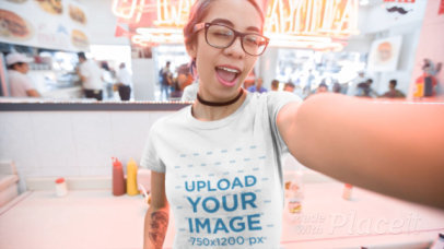 T-Shirt Video of a Woman Taking a Selfie in a Cafeteria