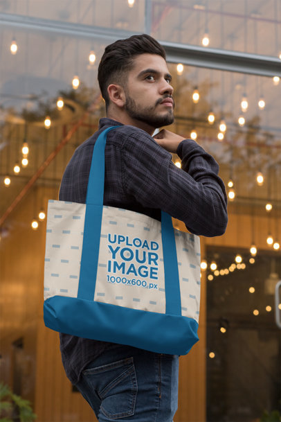 Mockup of a Bearded Man Carrying a Weekend Bag with Customizable Strap  on His Shoulder 
