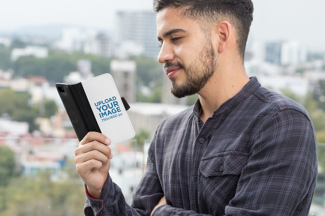 Wallet Case Mockup of a Bearded Man Browsing His iPhone 11