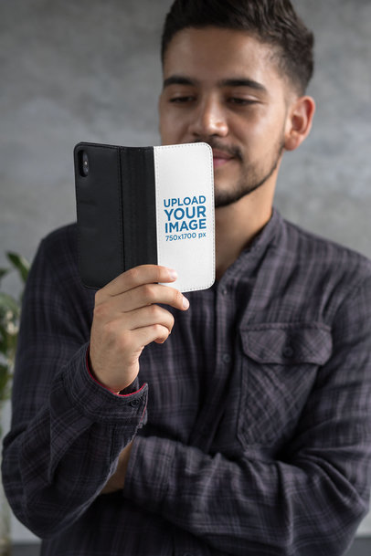 Wallet Case Mockup of a Man Looking at His iPhone X 29819