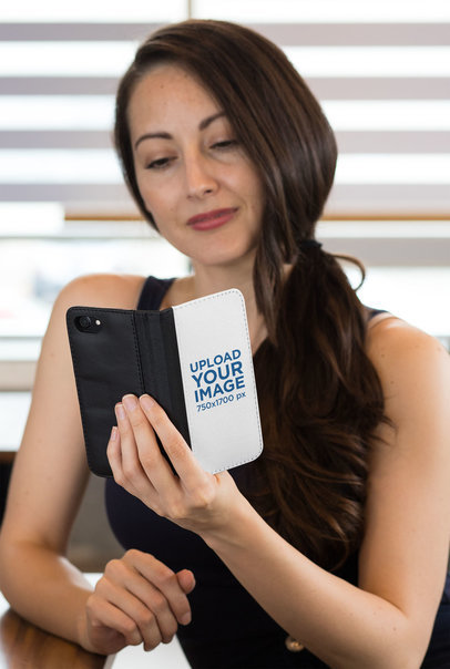 Mockup of a Woman with Long Hair Holding a Wallet Case for iPhone 29812