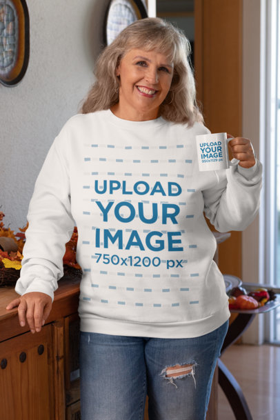 Mockup of an Elderly Woman with a Sweatshirt Holding an 11 oz Coffee Mug
