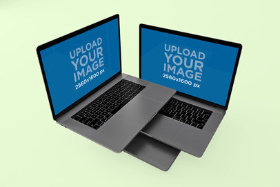 Mockup of Two Overlapped MacBook Pro In a Flat Surface 571-el