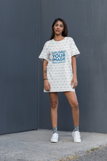Mockup of a Woman With a Shift Dress Standing Against a Gray Wall 29736
