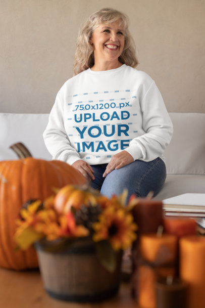 Sweatshirt Mockup of an Elderly Woman at a Thanksgiving-Decorated Living Room